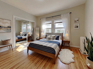 Oakland apartment for rent - A bedroom with a large bed and a mirror on the wall.