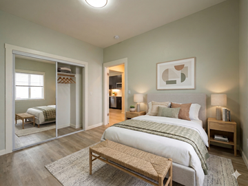 Oakland apartment for rent - A bedroom with a large bed and a wooden bench.