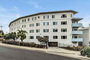 Oakland apartment for rent - A white building with a black gate in front.