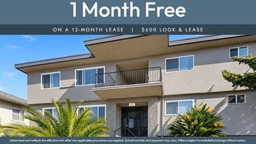 Oakland apartment for rent - A building with a sign offering a free month on a 12-month lease.