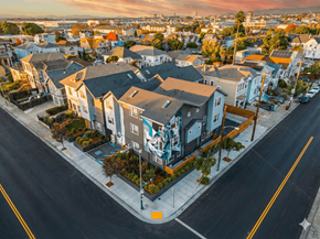 Oakland apartment for rent - A street view of a residential area with houses and parked cars.