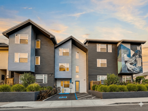 Oakland apartment for rent - A modern two-story apartment building with a mural on the side.