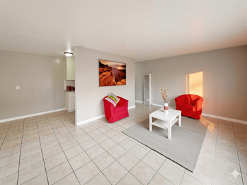 Oakland apartment for rent - A living room with a red chair and a white coffee table.