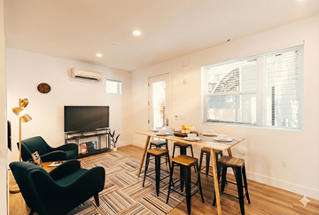 Oakland apartment for rent - A living room with a black chair and a wooden table.
