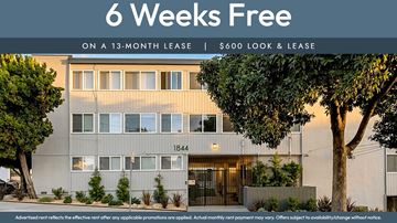 Oakland apartment for rent - A building with a sign offering 6 weeks free on a 13-month lease for $600.
