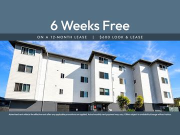 Oakland apartment for rent - A modern apartment building advertises a 6 weeks free offer on a 12-month lease.