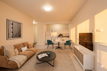 Oakland apartment for rent - A living room with a couch, coffee table, and a dining table set up in the background.