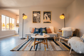 Oakland apartment for rent - A living room with a white couch, a coffee table, and two lamps.