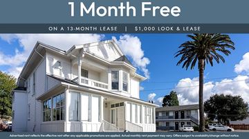 Fremont apartment for rent - A house with a palm tree in front and a sign that says "1 Month Free on a 13-month lease | $1,000 look & lease".
