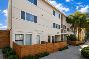 Oakland apartment for rent - A modern building with a wooden fence in front.