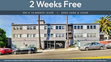 Oakland apartment for rent - A building with a sign offering a 2 weeks free on a 14-month lease.