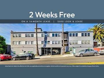 Oakland apartment for rent - A building with a sign offering a 2 weeks free on a 14-month lease.