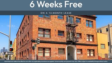 Oakland apartment for rent - A red brick building with a sign that says "6 Weeks Free on a 13-month lease".