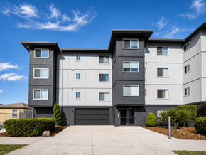 Oakland apartment for rent - A modern two-story residential building with a black garage door.