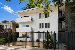 Oakland apartment for rent - A white modern house with a black fence in front.