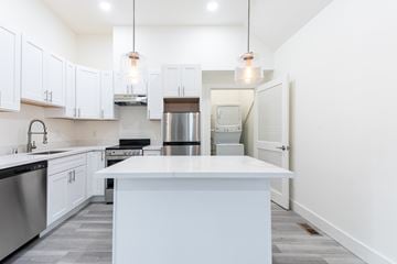 Fremont apartment for rent - A kitchen with white cabinets and a large island.
