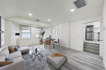 Fremont apartment for rent - A modern living room with a grey sofa and a glass coffee table.
