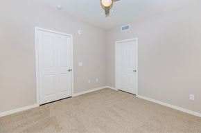 Los Alamitos apartment for rent - a bedroom with two doors and a carpeted floor