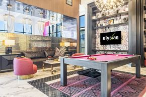 Las Vegas apartment for rent - A room with a pool table and a sign that says "Elysian".