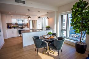 Oakland apartment for rent - A modern kitchen with a dining table set for four.