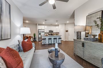 Dallas apartment for rent - A modern living room with a grey sofa and a grey coffee table.