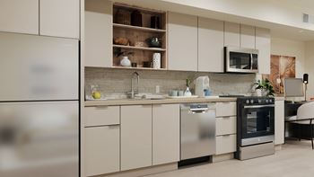 A modern kitchen with stainless steel appliances and white cabinets.