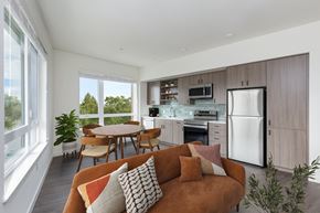 San Leandro apartment for rent - A modern kitchen with a brown couch and a dining table.