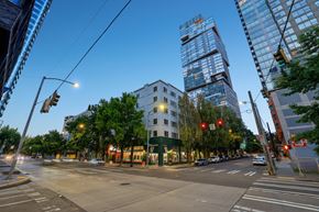 Seattle apartment for rent - A city street with a traffic light and a building in the background.
