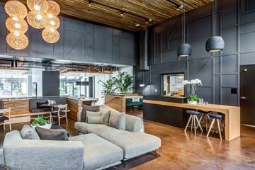 San Francisco apartment for rent - A modern living room with a grey sofa and a wooden ceiling.