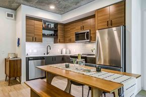 San Francisco apartment for rent - A modern kitchen with a wooden table and stainless steel appliances.