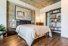 San Francisco apartment for rent - A bedroom with a large bed and a painting on the wall.