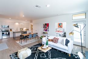 Oklahoma City apartment for rent - A modern living room with a white couch and a black and white rug.