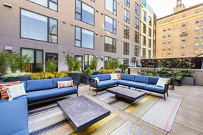 Oakland apartment for rent - a communal area with couches and tables in front of an apartment building
