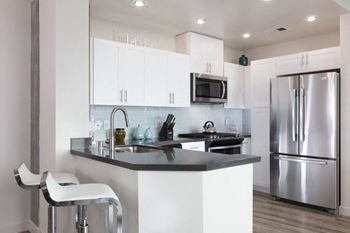 Kitchen with stainless steel appliances and bar seating