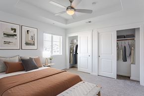 Roseville townhouse for rent - A bedroom with a bed, a ceiling fan, and a closet.