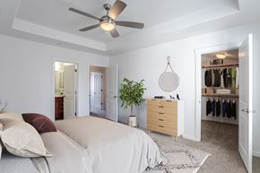 Roseville townhouse for rent - A bedroom with a bed, dresser, and closet.