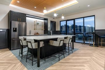 Bothell apartment for rent - A modern kitchen with a dining table and chairs.