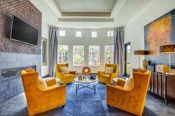 Las Vegas apartment for rent - A living room with a fireplace and a television on the wall.