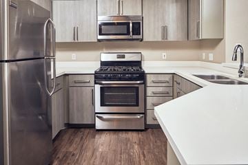 Escondido apartment for rent - a kitchen with stainless steel appliances and white counter tops