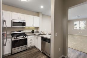 Ladera Ranch apartment for rent - a kitchen with white cabinets and stainless steel appliances at 55+ Remington at Ladera Ranch, California