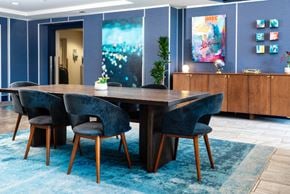 Oakland apartment for rent - furnished lobby with long table and lounge seating at Aqua Via Apartments, California, 94607