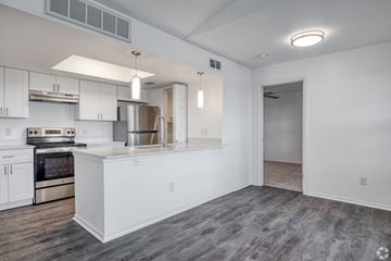 Killeen apartment for rent - A modern kitchen with white cabinets and stainless steel appliances.