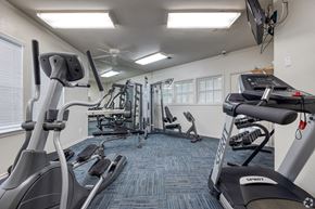 Killeen apartment for rent - A gym with a variety of equipment including treadmills, elliptical machines, and a television.