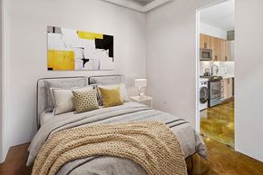 San Francisco apartment for rent - A bedroom with a large bed and a painting on the wall.