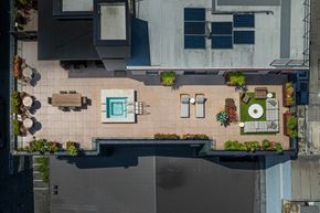 San Francisco apartment for rent - A rooftop patio with a table and chairs and a pool.