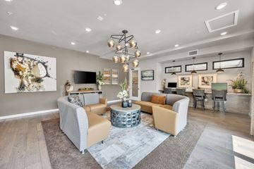 Upland apartment for rent - A modern living room with a large sectional sofa and a coffee table.