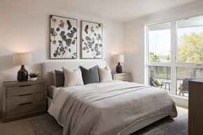 Mountain View apartment for rent - A bedroom with a large bed and two lamps on either side.