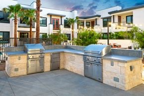 Palm Desert apartment for rent - A modern outdoor kitchen with a stone counter and stainless steel appliances.