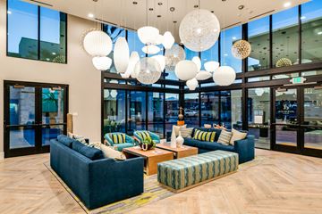 Palm Desert apartment for rent - A modern living room with a blue sofa and a wooden floor.