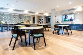 Palm Desert apartment for rent - A modern dining room with a large table surrounded by chairs.